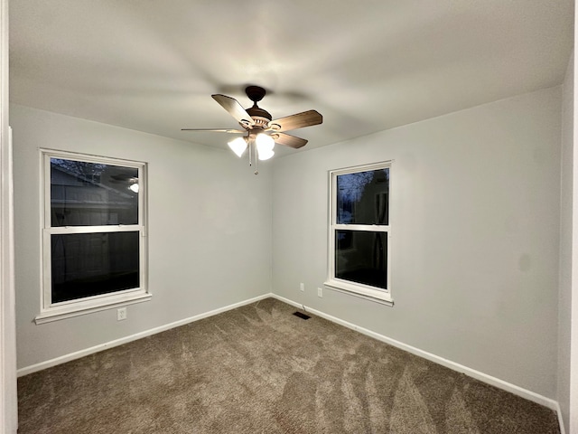 empty room featuring ceiling fan and carpet floors