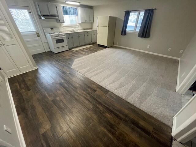 318 N Grand St, Schoolcraft, MI 49087 - kitchen featuring white appliances, a sink, dark wood-type flooring, gray cabinets, and under cabinet range hood