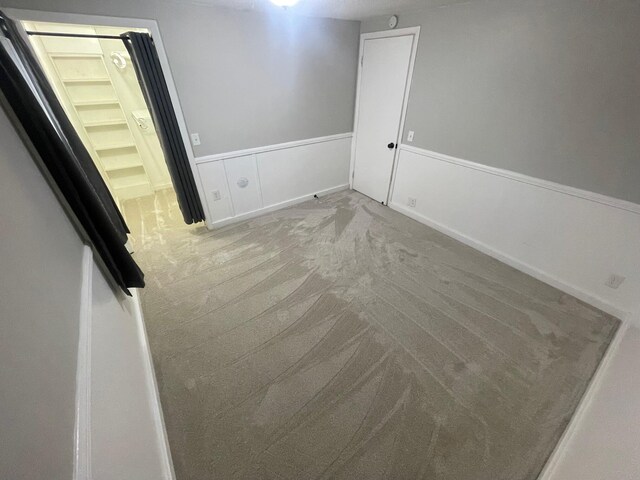 318 N Grand St, Schoolcraft, MI 49087 - carpeted empty room with wainscoting
