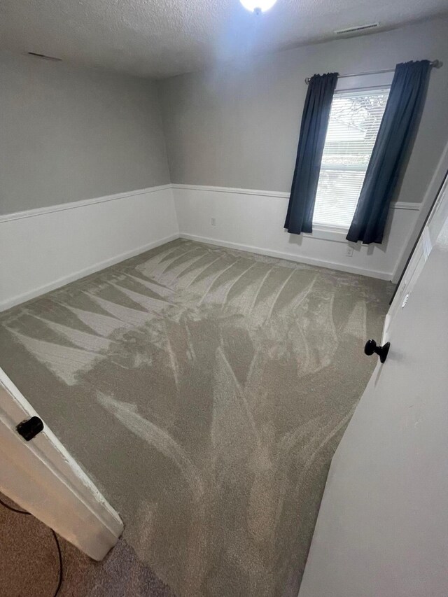 318 N Grand St, Schoolcraft, MI 49087 - carpeted empty room featuring a textured ceiling and baseboards