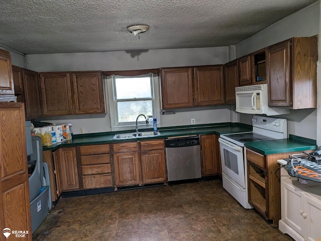 kitchen featuring a textured ceiling, white appliances, and sink