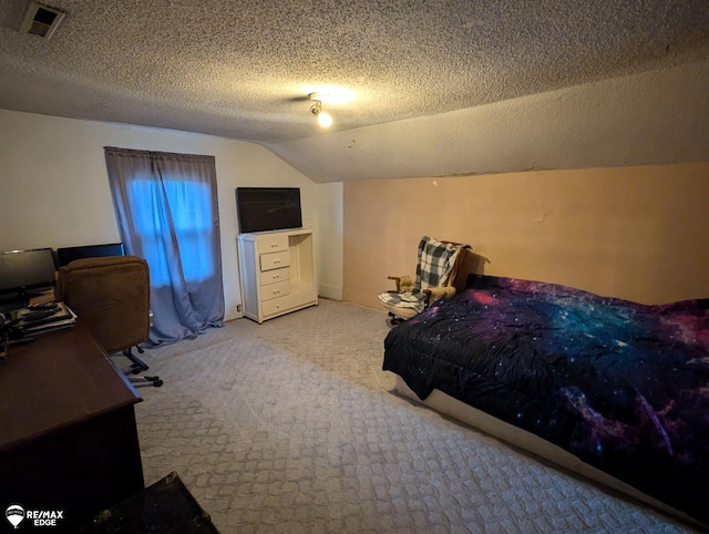 carpeted bedroom featuring a textured ceiling and vaulted ceiling