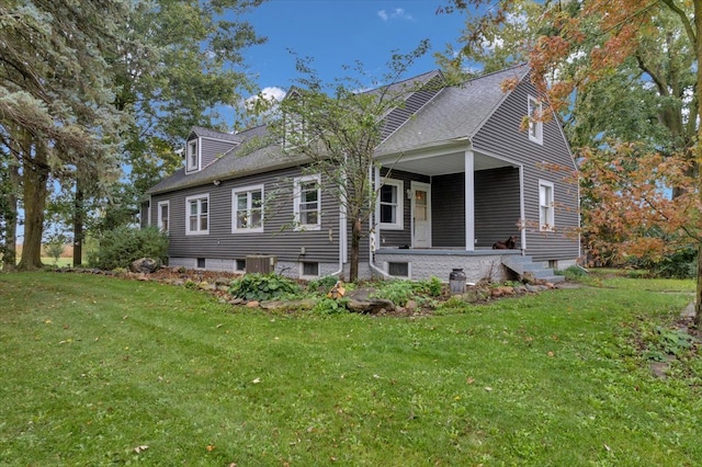 rear view of house featuring a lawn and central air condition unit