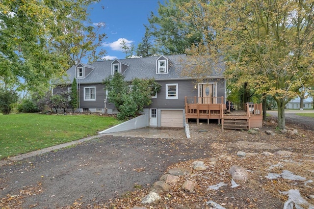 view of front of house featuring a garage, a wooden deck, and a front lawn