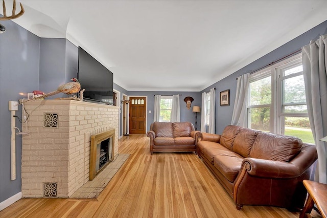 living room with a fireplace and light hardwood / wood-style flooring