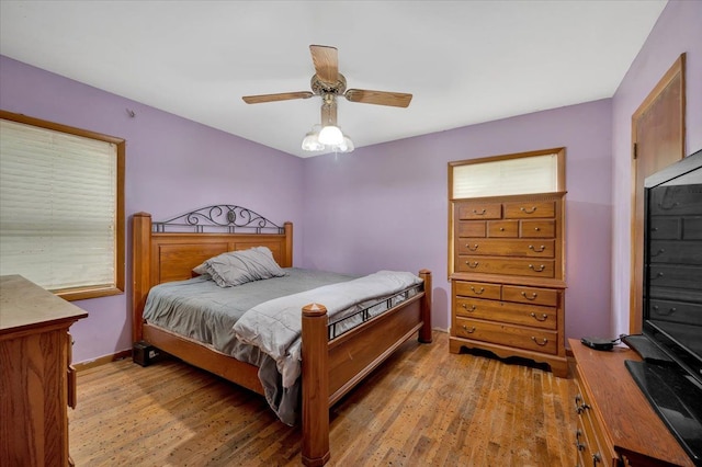 bedroom with ceiling fan and light wood-type flooring