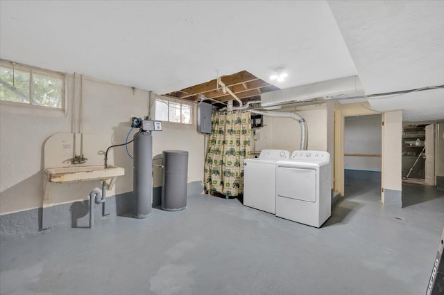 basement featuring washing machine and dryer and electric panel