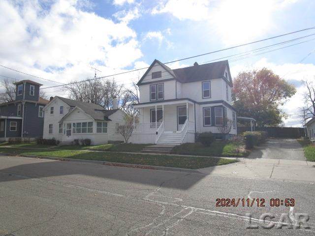 view of front of home with a front lawn and a porch