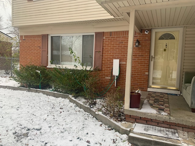 view of snow covered property entrance