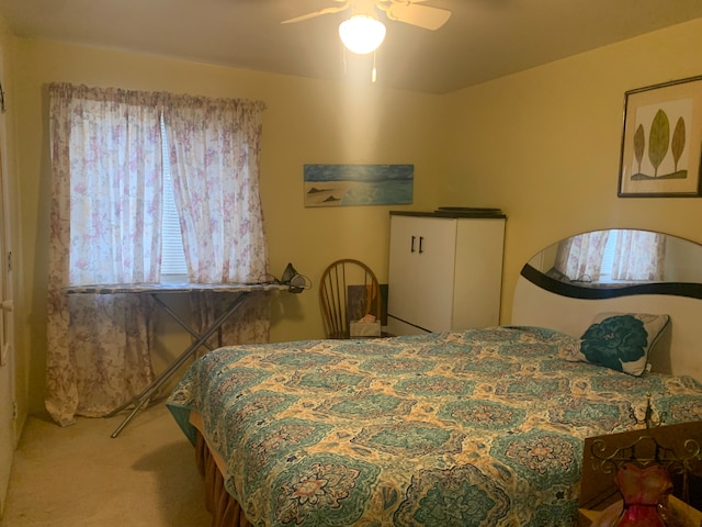 bedroom featuring ceiling fan and carpet