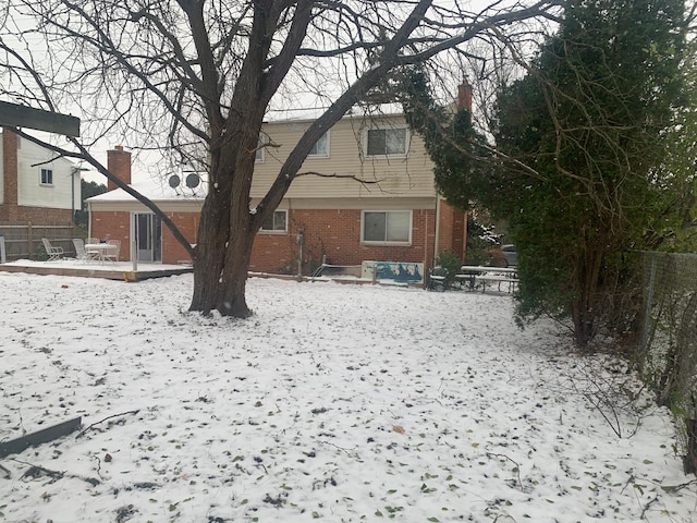 view of snow covered rear of property