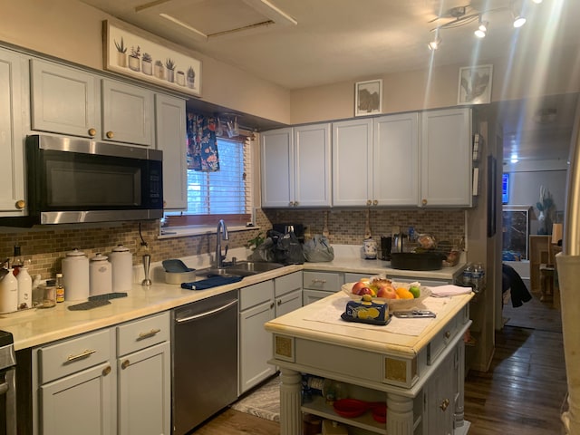 kitchen with decorative backsplash, wood-type flooring, and stainless steel appliances