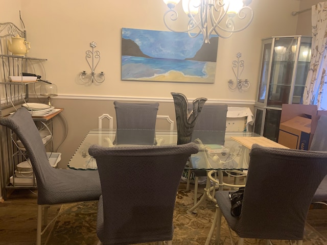 dining room featuring wood-type flooring and a chandelier