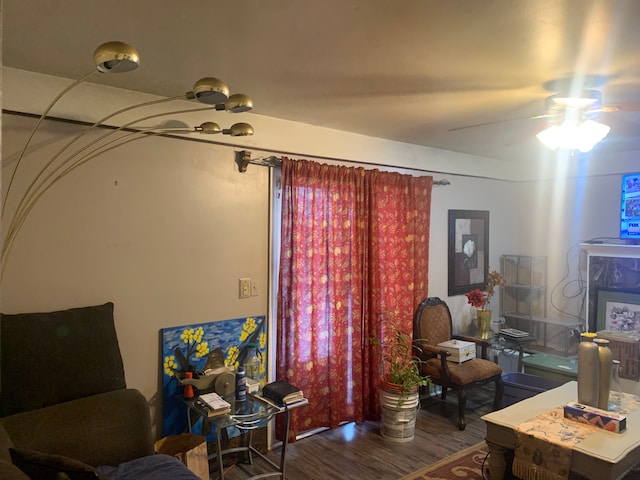 living room with wood-type flooring and ceiling fan