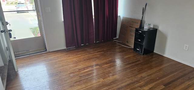 unfurnished bedroom with dark hardwood / wood-style flooring