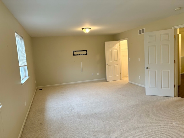 spare room with light colored carpet