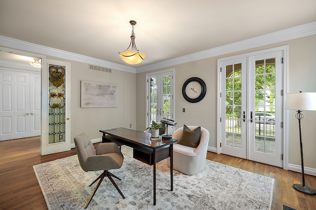 home office with crown molding, hardwood / wood-style floors, and french doors