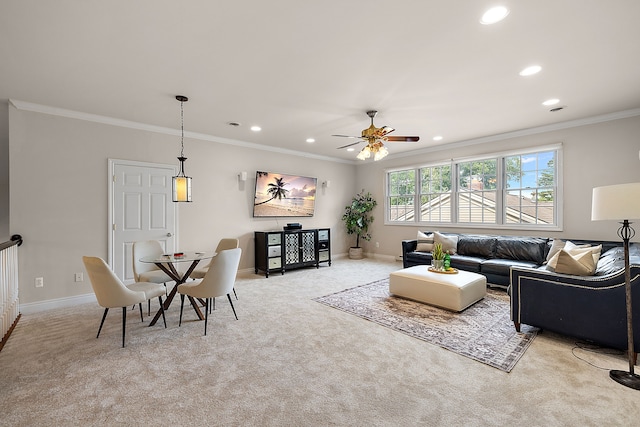 carpeted living room with crown molding and ceiling fan