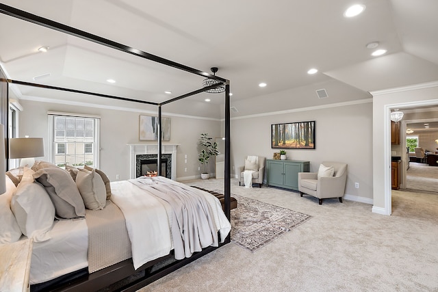 carpeted bedroom with ceiling fan, ornamental molding, a fireplace, and a raised ceiling