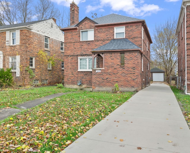 view of property exterior with a lawn, a garage, and an outbuilding