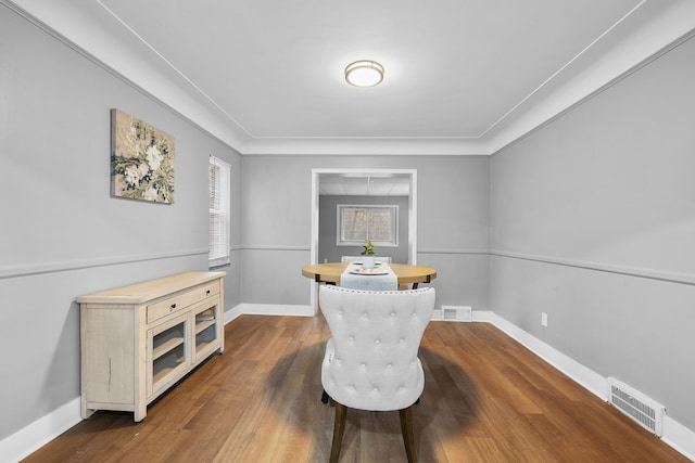 sitting room with dark hardwood / wood-style floors and crown molding