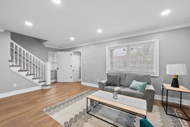 living room featuring hardwood / wood-style floors and crown molding