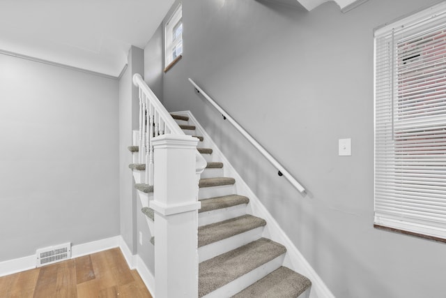 stairway with hardwood / wood-style floors