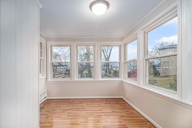 unfurnished sunroom featuring baseboard heating