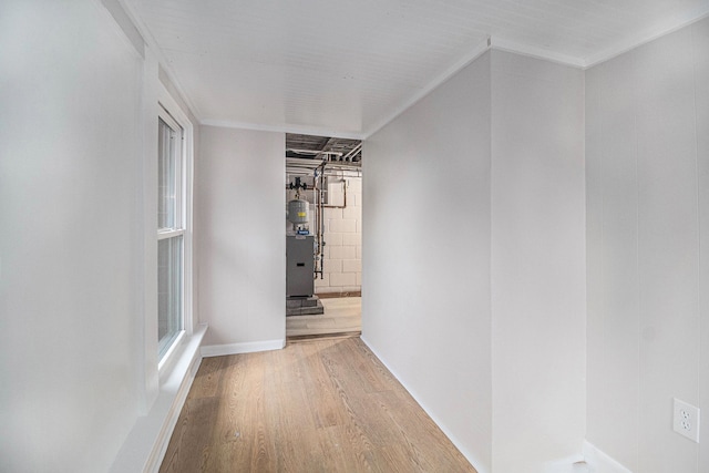 corridor with hardwood / wood-style flooring and crown molding