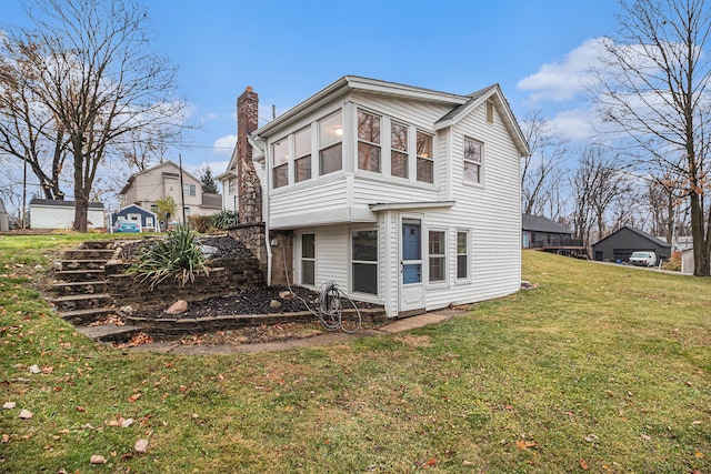 back of house featuring a yard