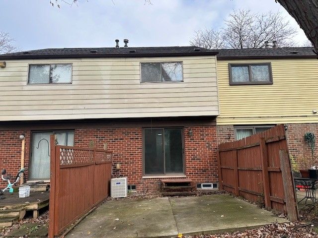 rear view of house with cooling unit and a patio