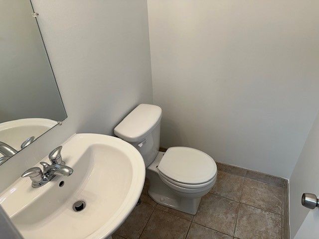 bathroom with tile patterned floors, toilet, and sink