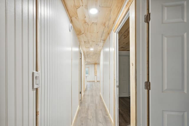 hall featuring light hardwood / wood-style floors and wood ceiling