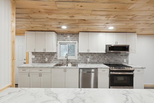 kitchen featuring light stone countertops, white cabinetry, sink, and stainless steel appliances