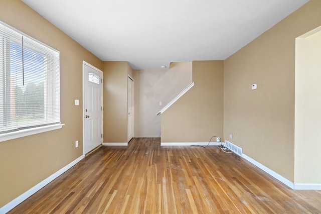 foyer with plenty of natural light and hardwood / wood-style floors