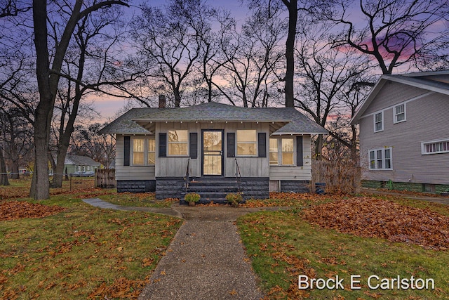 bungalow featuring a yard