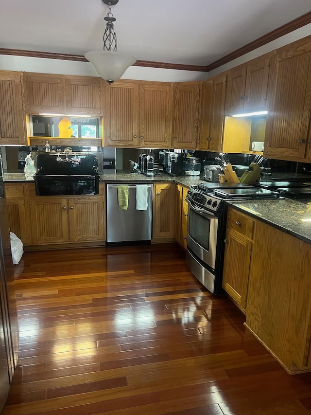 kitchen featuring crown molding, dark hardwood / wood-style flooring, and stainless steel appliances