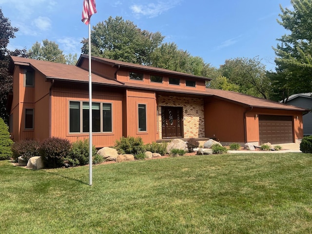 view of front of property with a garage and a front yard