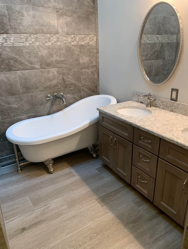 bathroom featuring vanity and a tub to relax in