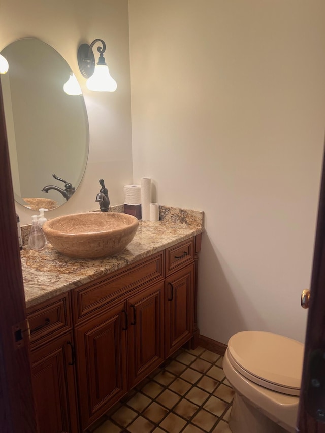 bathroom with tile patterned floors, vanity, and toilet