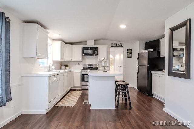 kitchen featuring dark hardwood / wood-style flooring, a breakfast bar, a kitchen island with sink, black appliances, and white cabinets