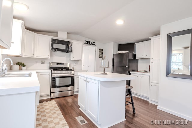 kitchen featuring black appliances, white cabinets, sink, a kitchen island, and dark hardwood / wood-style flooring