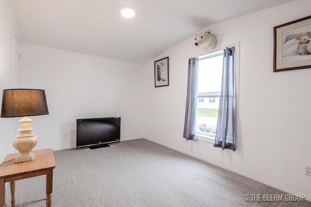 unfurnished room with carpet and lofted ceiling