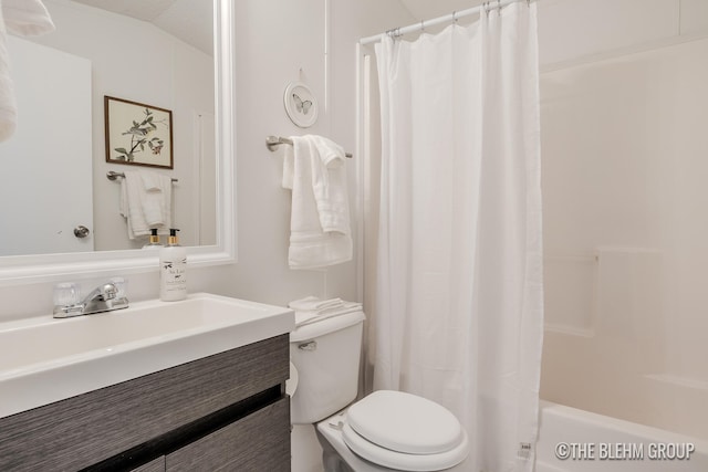 full bathroom with vanity, toilet, shower / bathtub combination with curtain, and vaulted ceiling