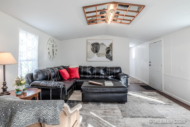 living room with hardwood / wood-style flooring and vaulted ceiling