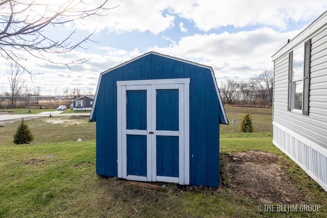 view of outbuilding featuring a yard