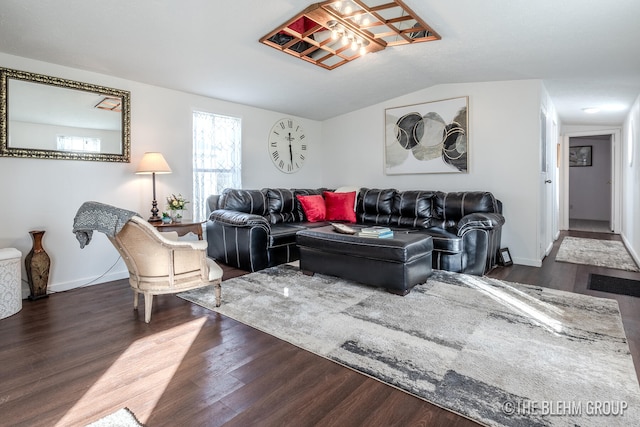 living room with dark hardwood / wood-style flooring and vaulted ceiling