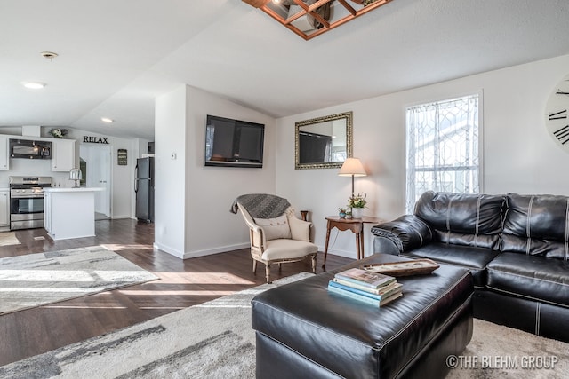 living room featuring dark hardwood / wood-style floors and vaulted ceiling