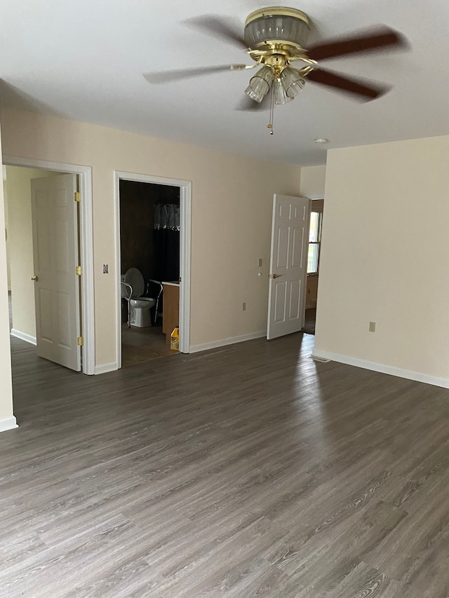 spare room with ceiling fan and dark wood-type flooring