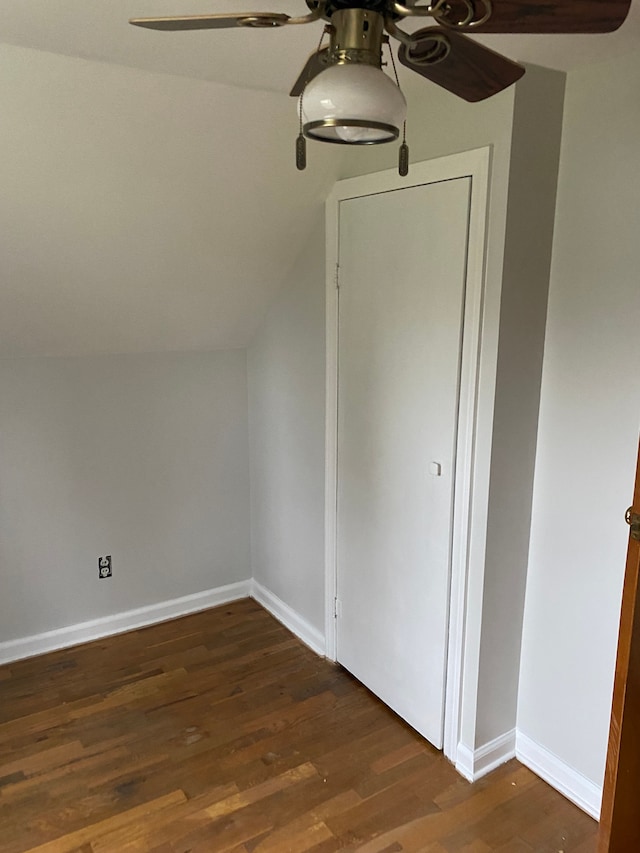 bonus room with dark hardwood / wood-style floors and lofted ceiling